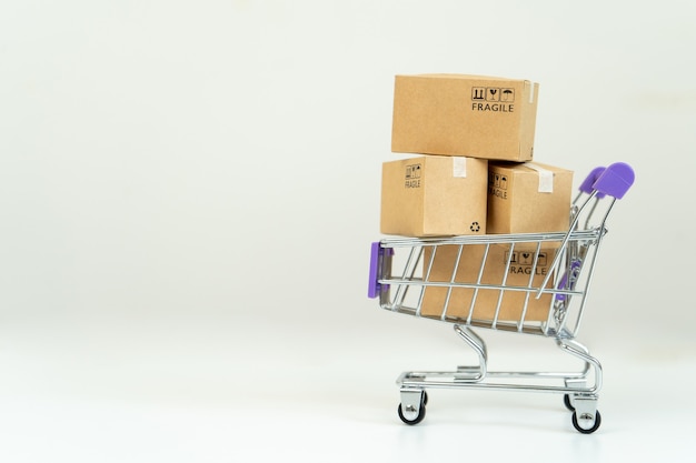 Paper boxes in a trolley with credit card. Online shopping or e-commerce concept