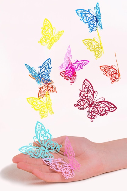 Paper butterflies fly out of girl's hands