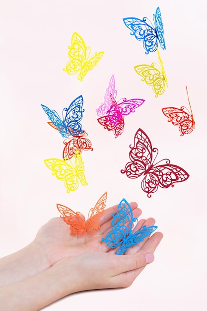 Paper butterflies fly out of girl's hands