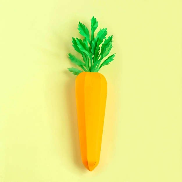 Paper carrot on yellow background