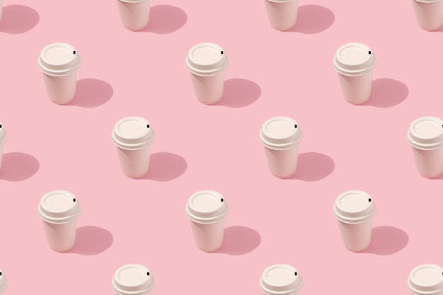 Paper coffee cups pattern on a pink background