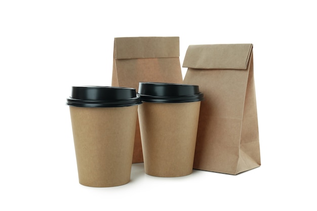 Paper cups and paper bags isolated on white surface