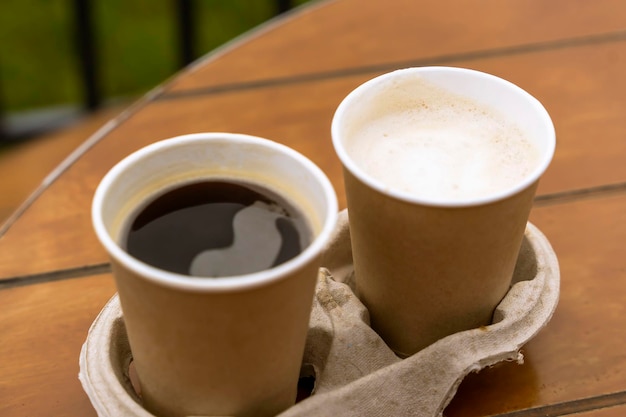 Paper cups with coffee on the table of an outdoor cafe Takeaway food