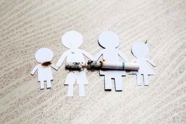 Paper cut of family destroyed by cigarettes Drugs destroying family concept World no tobacco day