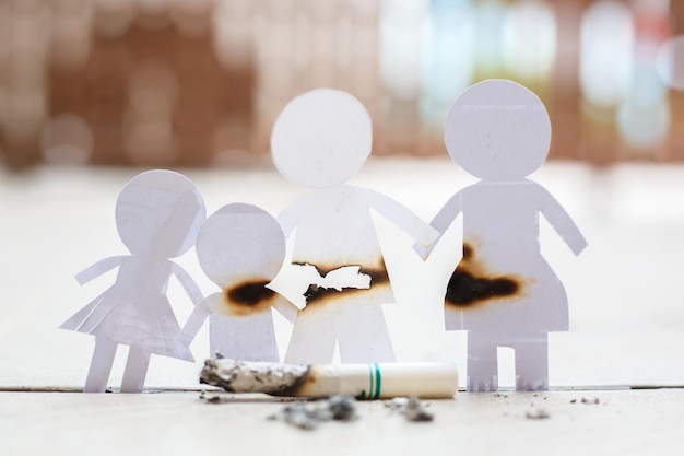 Paper cut of family destroyed by cigarettes Drugs destroying family concept World no tobacco day