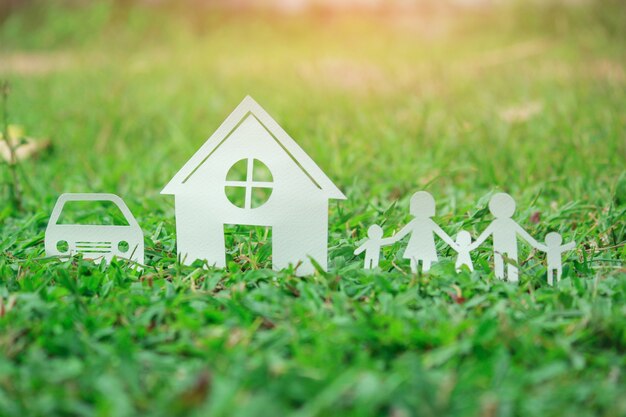 Paper cut of family on green grass, Concepts saving money for House and car