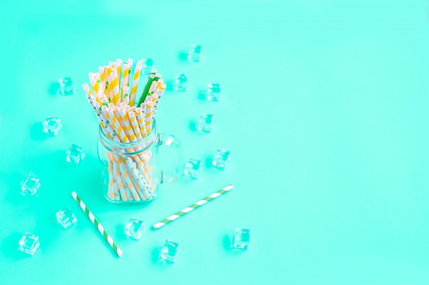 Paper disposable straws for summer cocktails and ice cube