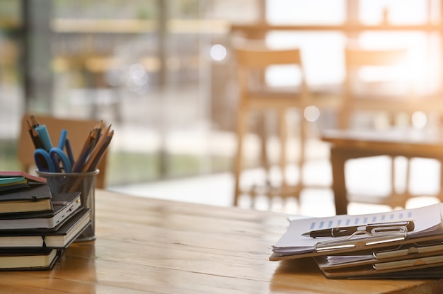 Paper document files and pen business equipment on wooden desk.