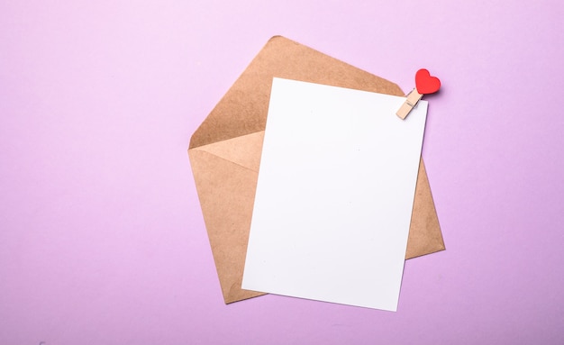 Paper envelope with Valentines hearts on purple background. Flat lay, top view. Romantic love letter for Valentine's day concept.