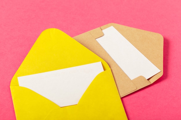 Paper envelopes on a colored pink background