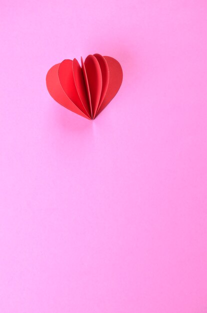 Paper heart on pink