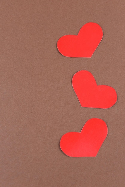 Paper hearts on brown background