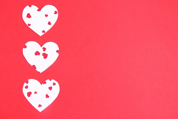 Paper hearts on red background