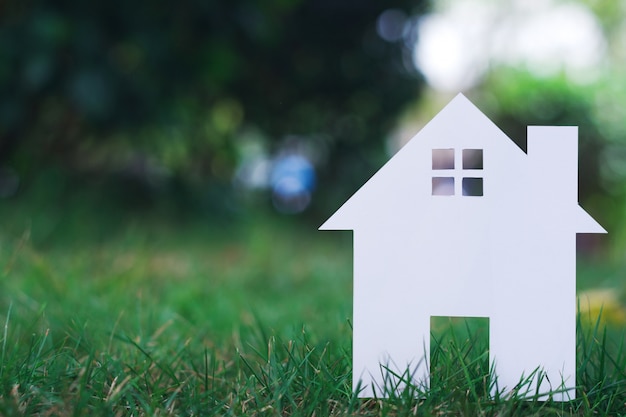 Paper House on field bokeh background with copy space