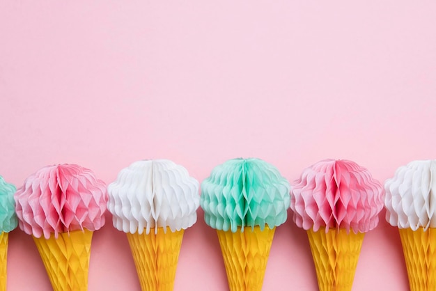 Paper ice cream cone decoration on a pastel pink background