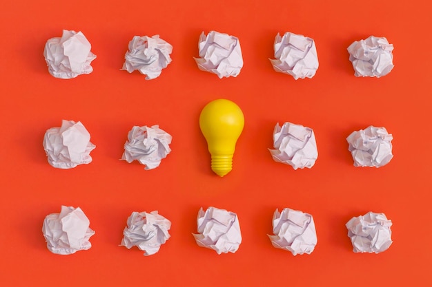 Paper and light bulb on yellow background Idea concept