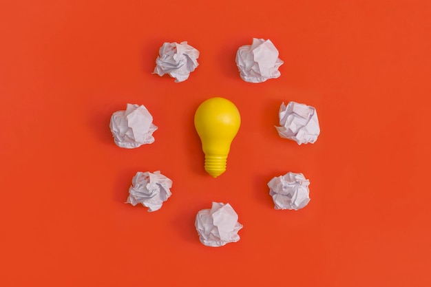 Paper and light bulb on yellow background Idea concept