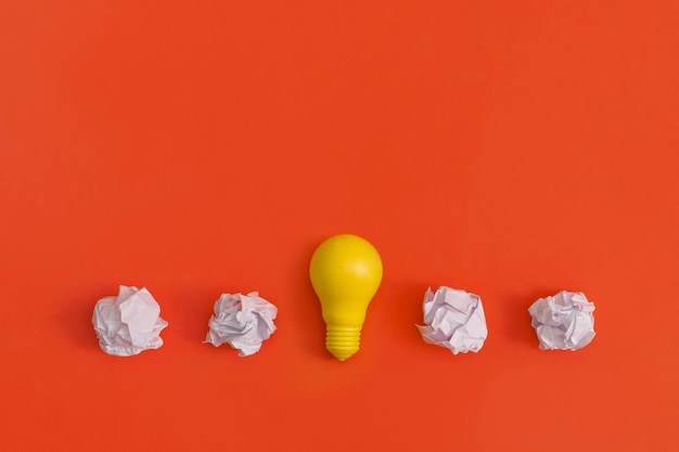 Paper and light bulb on yellow background Idea concept