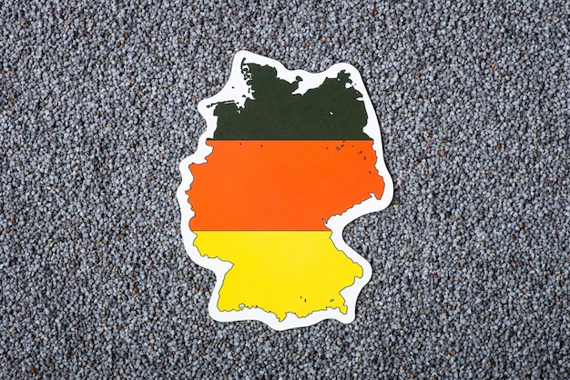 Paper map of Germany on poppy seed Origin of grain growing poppy plant in Germany