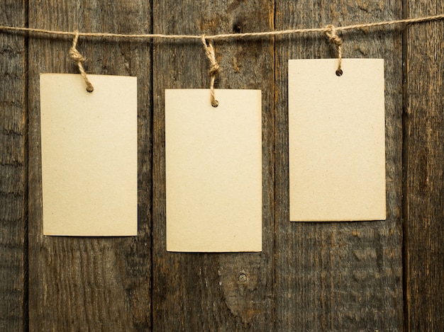 Paper notes on rope on wooden background. Copy space.