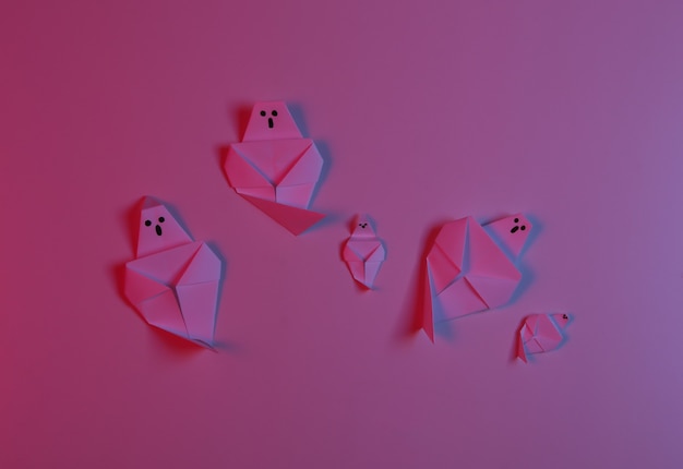 Paper Origami ghosts in red blue neon light. Halloween theme