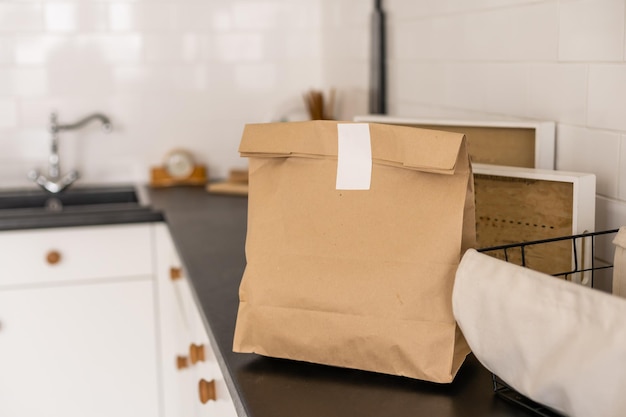 Paper packages with groceries on kitchen table.