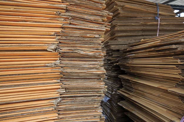 Paper pile and piece of cardboard at the recycle industry paper plant