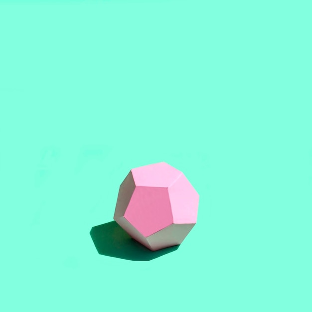 Paper pink dodecahedron in bright sunshine