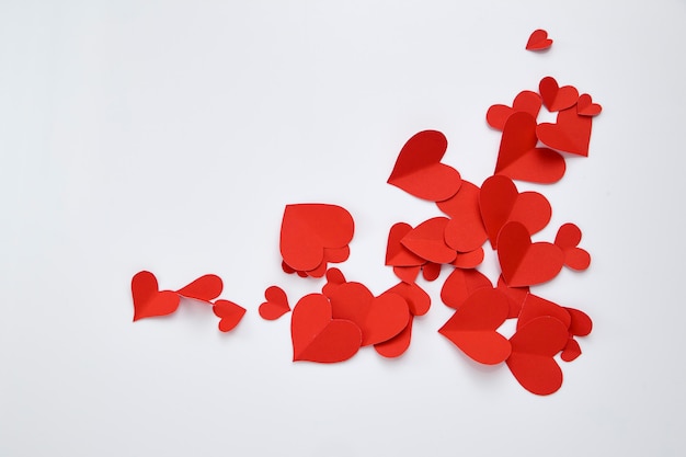 Paper red hearts on white background