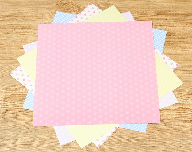 Photo paper for scrapbooking on wooden table