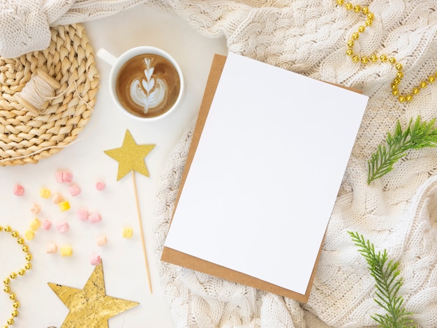 Paper sheet xmas card mockup with holiday decorations in green and golden colors on white background