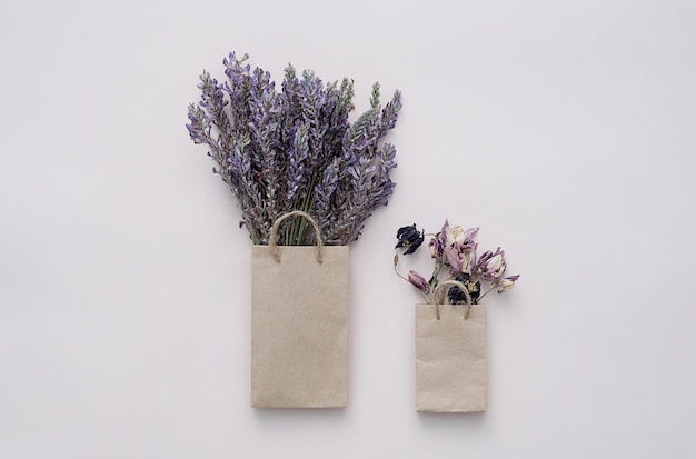 Paper shopping bag with dried flowers bouquet Autumn gift sales concept