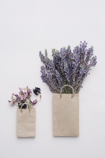 Paper shopping bag with dried flowers bouquet Autumn gift sales concept