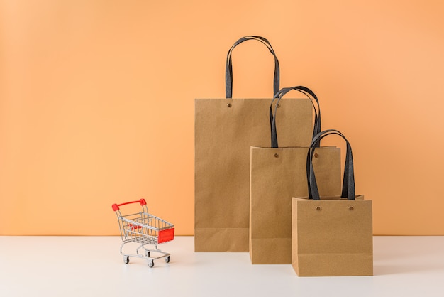 Paper shopping bags and shopping cart or trolley