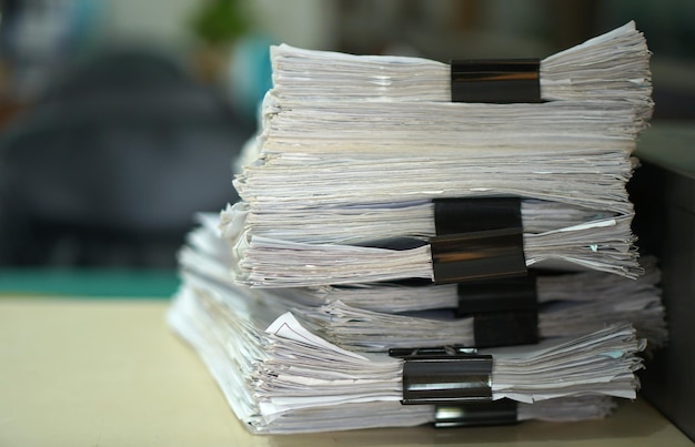 Paper stack on the desk related to business functions With morning lightsoft focus