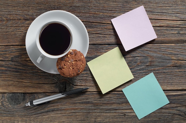 Paper sticky notes and coffee