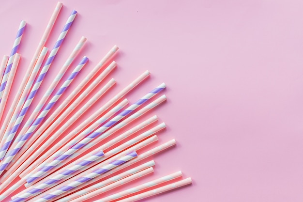 Paper straw on pink background