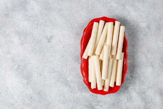 Paper straws of different colors on light background with copy space