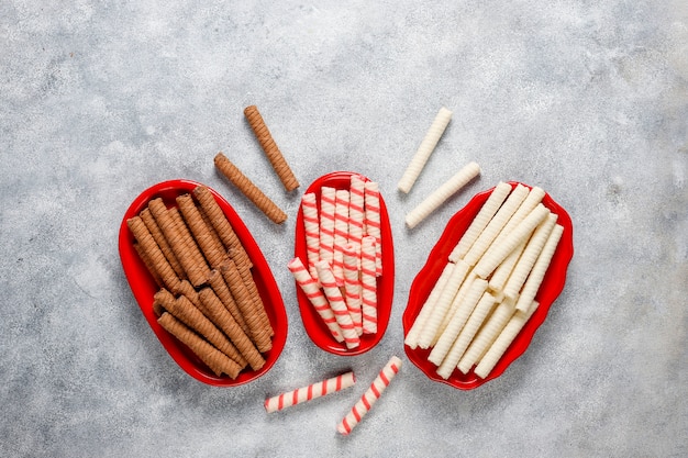 Paper straws of different colors on light background with copy space