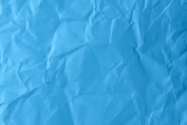 Paper textured background from crumpled blue paper close-up macro photography high detail