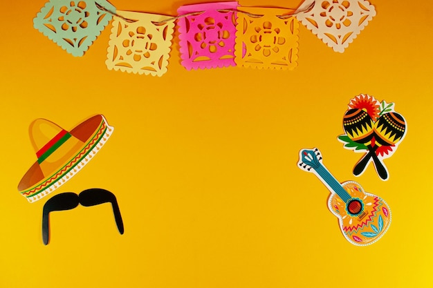 Paper traditional banner flag mexican hat and decoration Happy Cinco de Mayo top view background