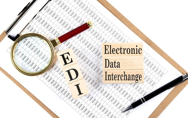 Paper with EDI Electronic Data Interchange a table on a charts business concept