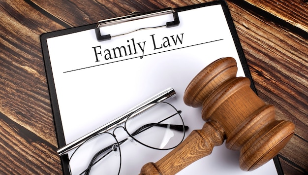 Paper with FAMILY LAW with gavel, pen and glasses on the wooden surface