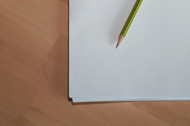 Paper with pencil on wooden table Pencil on table the blogger instrument