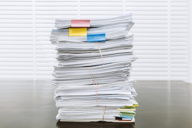 Paperwork pile print document unorganized put on the desk