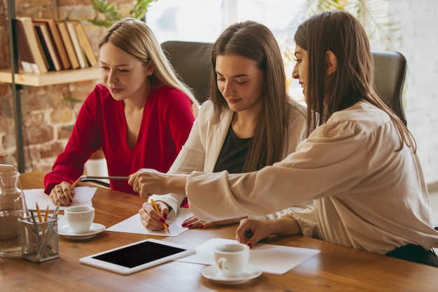 Paperwork. Young business woman in modern office with team. Creative meeting, tasks giving. Women in front-office working. Concept of finance, business, girl power, inclusion, diversity, feminism.