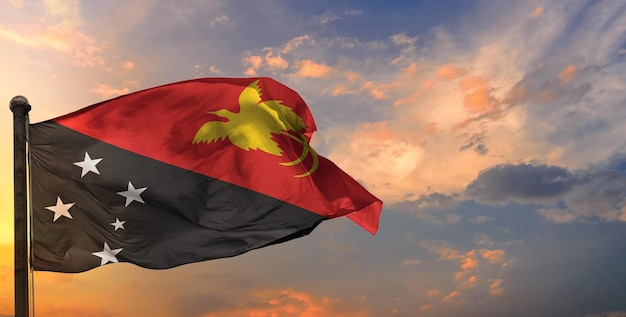 The papua_new_guinea waving flag and sky background.