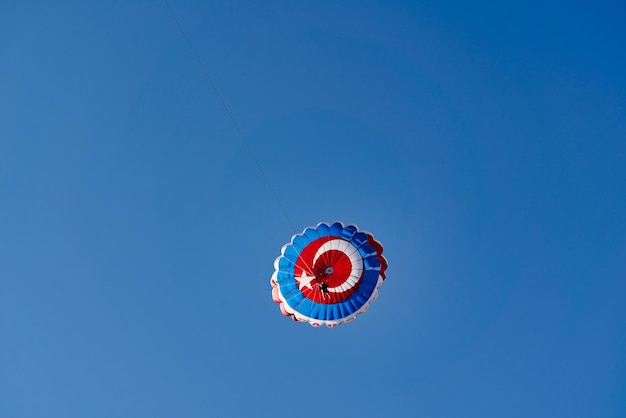 Parachute with the flag of turkey against the blue sky