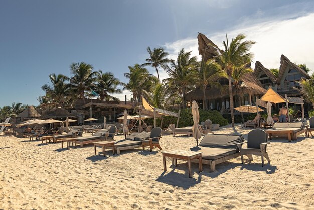 Paradise beach at Tulum, sun umbrellas and sun beds on the beach, Tulum, Mexico