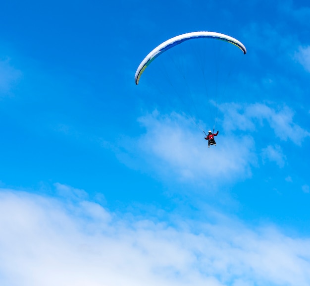 Paraglider flies paraglider in the sky.